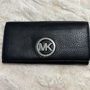Authentic Michael Kors leather wallet. Black. Lightly used.